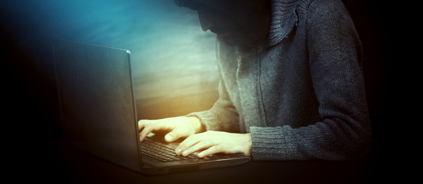 haker hands typing on laptop keyboard