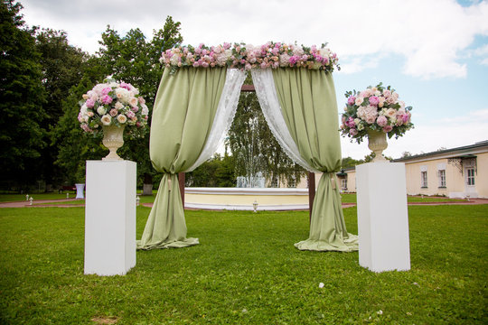 Beautiful wedding ceremony outdoors. Decorated chairs stand on the grass. rustic style.