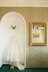 White Wedding dress hanging on arch