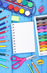 School accessories with notepad on blue boards, back to school concept