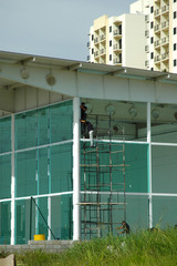 glaziers on scaffolding with no harness - unsafe work without protective gear or fall arrest apparatus