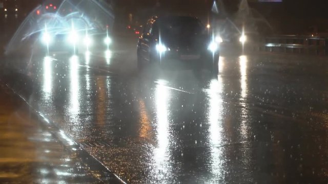 slow motion video of night traffic in a heavy downpour