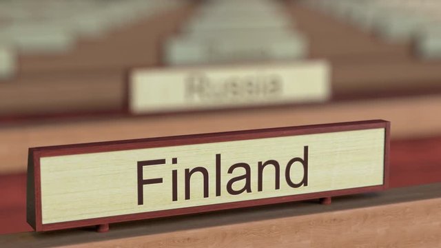 Finland name sign among different countries plaques at international organization. 3D rendering
