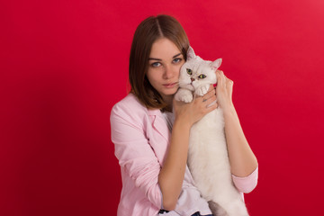 Fototapeta na wymiar Young cute girl with cat, studio 