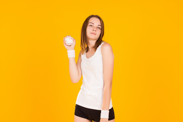 Young cute girl with baseball ball, studio  