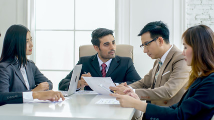 The chief is explaining the information to the executives during the meeting.