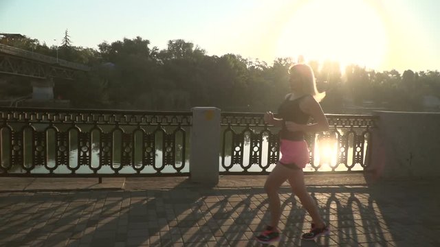 woman runner jogging on the river side road