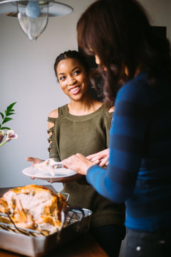 Two women sharing meal during Thanksgiving dinner