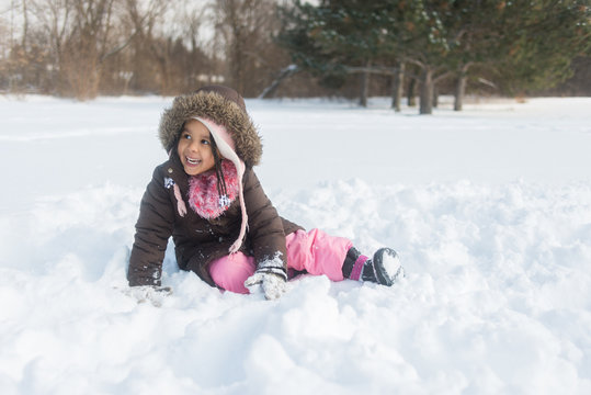 Young black girl playing in the snow.