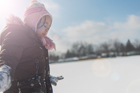 Young Black Girl Playing In The Snow.