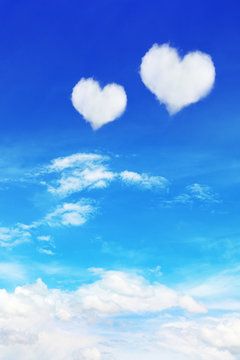 two heart shaped clouds on blue sky for valentine background