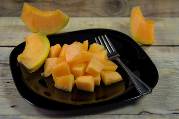 Summer fruits. Tasty and juicy cut melon into cubes served on a plate