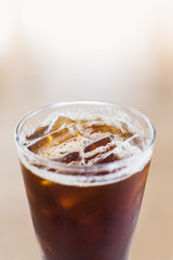 Ice coffee americano on the white mable table close up soft focus