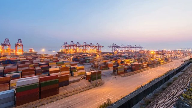 time lapse of shanghai container terminal in nightfall, busy modern harbor

