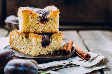 Homemade pie with plums on the table, copy space