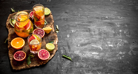 Citrus background. Fresh citrus juice with slices of limes, oranges, grapefruits and lemons.