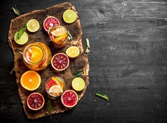 Fototapeta na wymiar Citrus background. Fresh citrus juice with slices of limes, oranges, grapefruits and lemons.