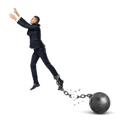 A businessman leaping away from an attached iron ball with a broken chain.