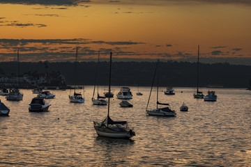 Sunset over a marina full of small boats