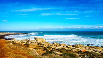 Fototapeta na wymiar Waves rolling on to the shoreline of the Atlantic Ocean coast at Cape of Good Hope in Cape Point Nature Reserve on the Cape Peninsula in South Africa