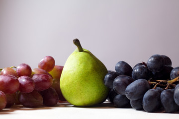 Fruits on light background. pear, grape
