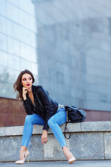 Young woman posing in black jacket. Fashion makeup