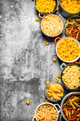 Pasta background. Many different pasta in bowls.