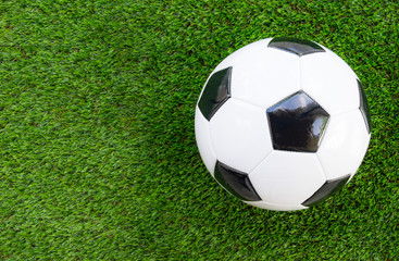 Soccer concept : Football (soccer ball)  on green grass background. Flat lay with copy space.