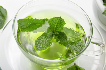 Cup of herbal tea on white background, closeup. Weight loss concept