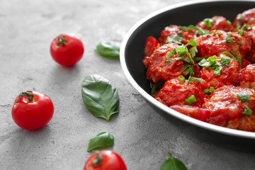 Frying pan with delicious turkey meatballs on table