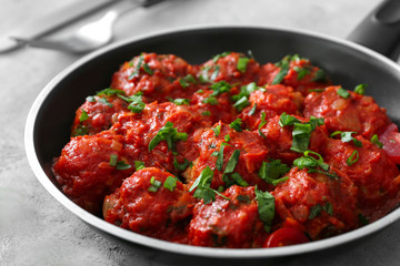 Frying pan with delicious turkey meatballs on table