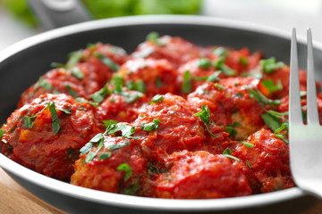 Closeup view of frying pan with turkey meatballs and tomato sauce