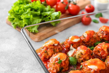 Delicious turkey meatballs in glass casserole dish on light table