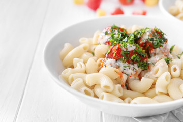 Plate with delicious pasta and turkey meatballs on white wooden table