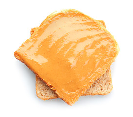 Bread slice with creamy peanut butter on white background