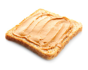 Bread slice with creamy peanut butter on white background