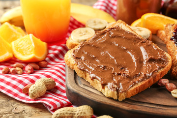 Tasty sandwiches with peanut butter on table