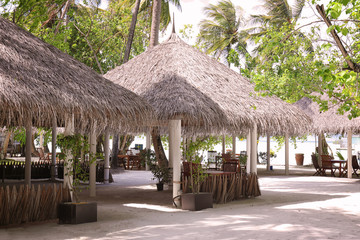 Fototapeta na wymiar Cafe on sea beach at tropical resort
