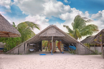 Fototapeta na wymiar Shelter shed with surf boards on sea beach at tropical resort