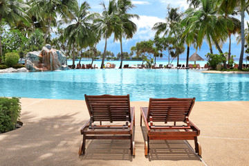Sun loungers near pool at sea resort