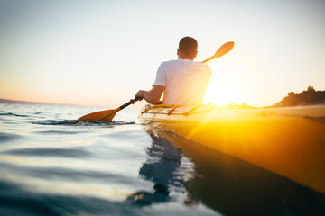 Kayaker paddling the kayak  - obrazy, fototapety, plakaty