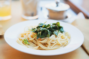 Spaghetti with Parmesan and spinach. A traditional Italian dish.
