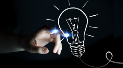 Businesswoman touching a sketch lightbulb