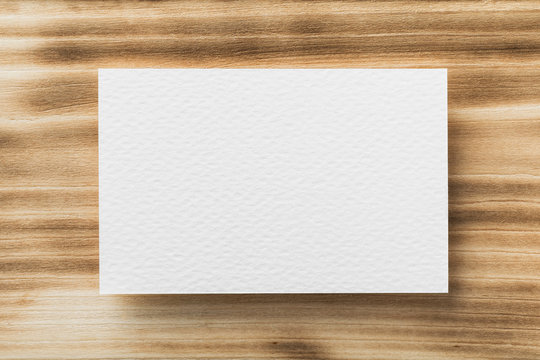 Closeup Mockup Of White Blank Horizontal Business Card At Natural Wooden Background.