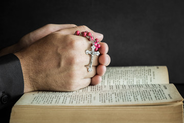 Opened bible in the quiet, dark atmosphere. Prayer time on sunday.