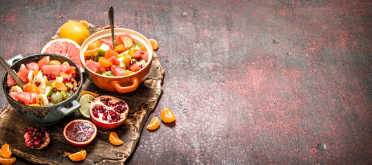 Summer food. Tropical salad of exotic fruits.