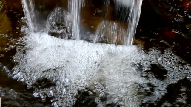 The fountain in the garden. Splashing water from a fountain in the garden.