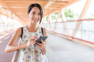 Woman using mobile phone in the street