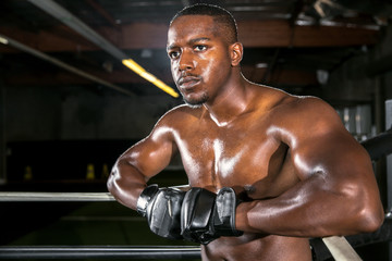 Obraz na płótnie Canvas Handsome attractive african american boxer mma fighter exercise fitness athlete resting