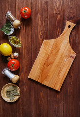 kitchen cooking background with oil and spices on wooden table 